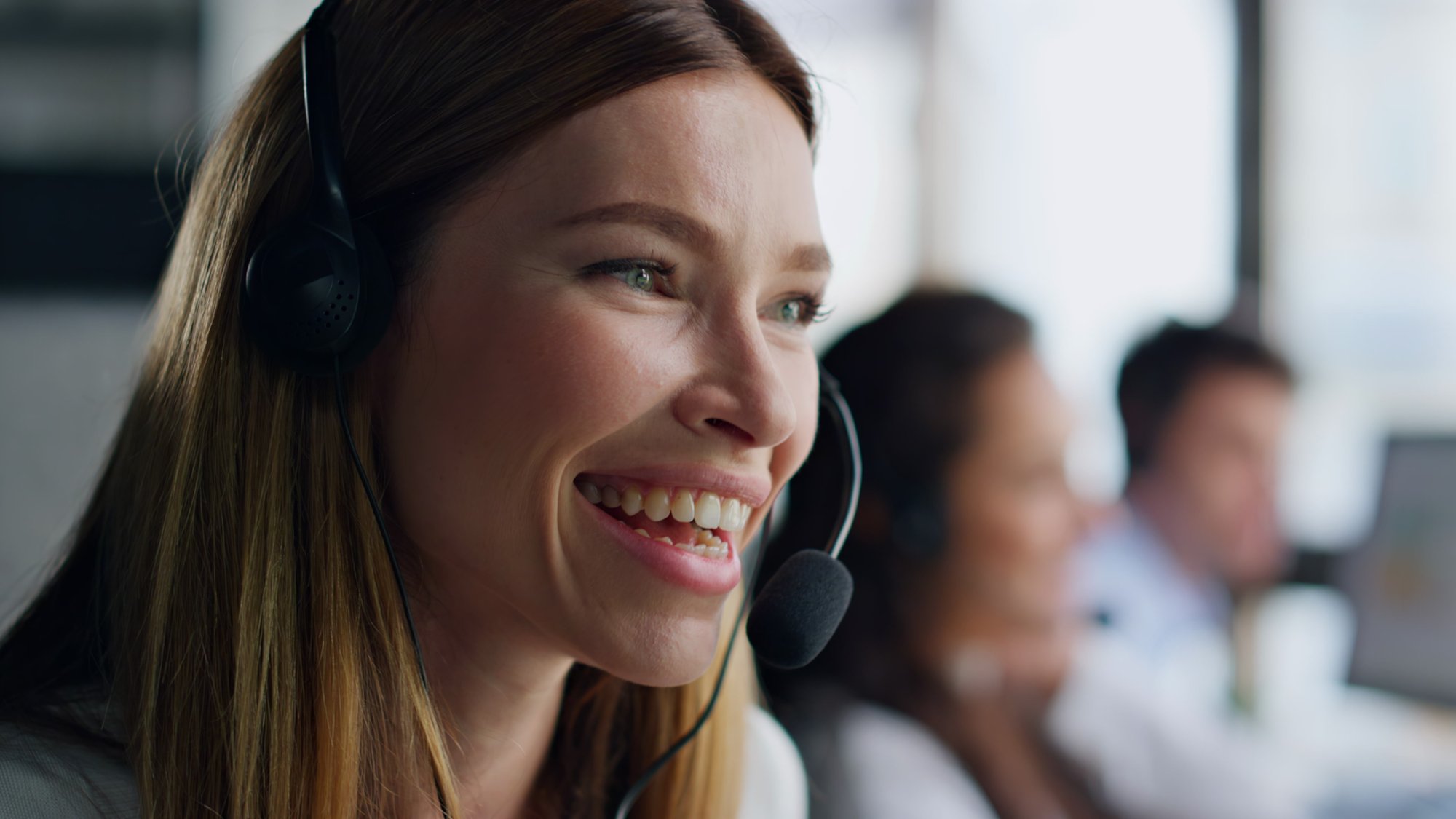 joyful-agent-speaking-headset-closeup-smiling-wom-2024-11-05-04-23-07-utc
